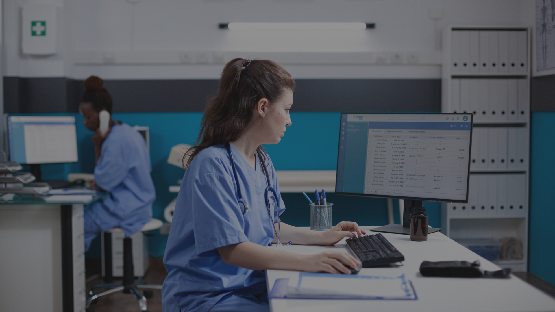 Static image for the healthcare video header presenting a nurse working at her desk